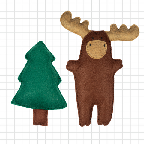 Felt moose and tree toy on a grid background
