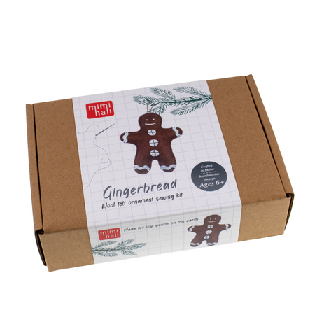 Gingerbread-themed sewing kit packaging with a cardboard box and white label featuring a gingerbread man.