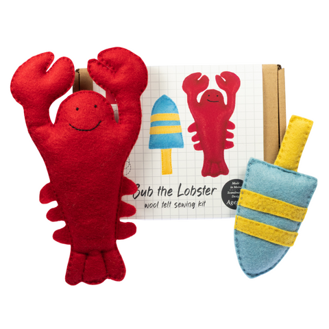 Red lobster plush toy with a sewing kit on a white background