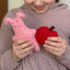 kid holding felt pig and apple