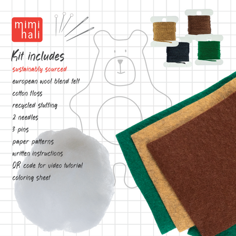 Craft kit with felt pieces, threads, needles, and pins on a grid background