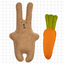 Brown rabbit-shaped toy with a green tail and orange carrot on a grid background