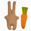 Brown rabbit-shaped toy with a green tail and orange carrot on a grid background
