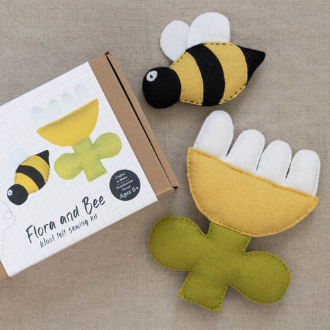 Felt bee and flower toy set with packaging on a beige background
