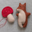 Felt fox and mushroom toys on a neutral background