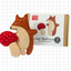Felt fox and mushroom toy set with packaging on a grid background