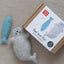 Wool felt seal and fish toy with packaging on a neutral background