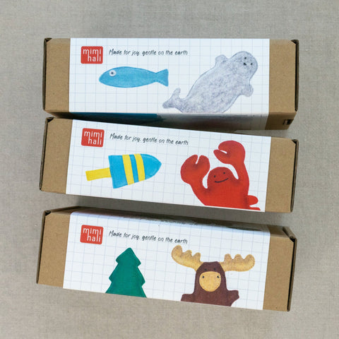 Three cardboard boxes with animal photos and 'mimihali' branding on a neutral background