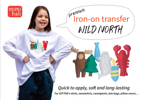 Girl wearing a white sweatshirt with 'Wild North' iron-on transfers and mimihali branding.