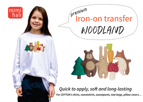 Girl wearing a white shirt with woodland-themed iron-on transfers, featuring bear, bunny, fox and tree, carrot, and mushroom. Mimihali branding is visible.