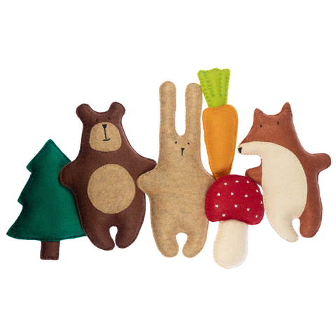 Set of soft toy animals including a bear, rabbit, fox, carrot, mushroom, and tree on a white background
